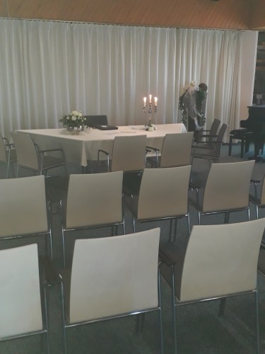 Trausaal im Ratssaal mit Tisch mit wei&szlig;er Tischdecke, Kerzen und Blumen und mit Bestuhlung